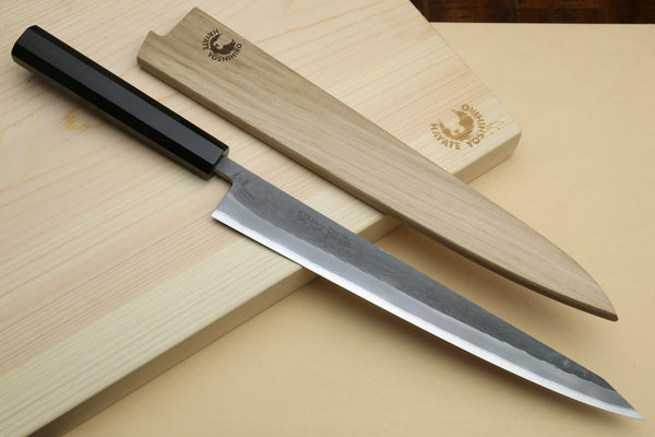 Slicer knife with ebony handle and silver blade with light wooden saya-style cover pieces.