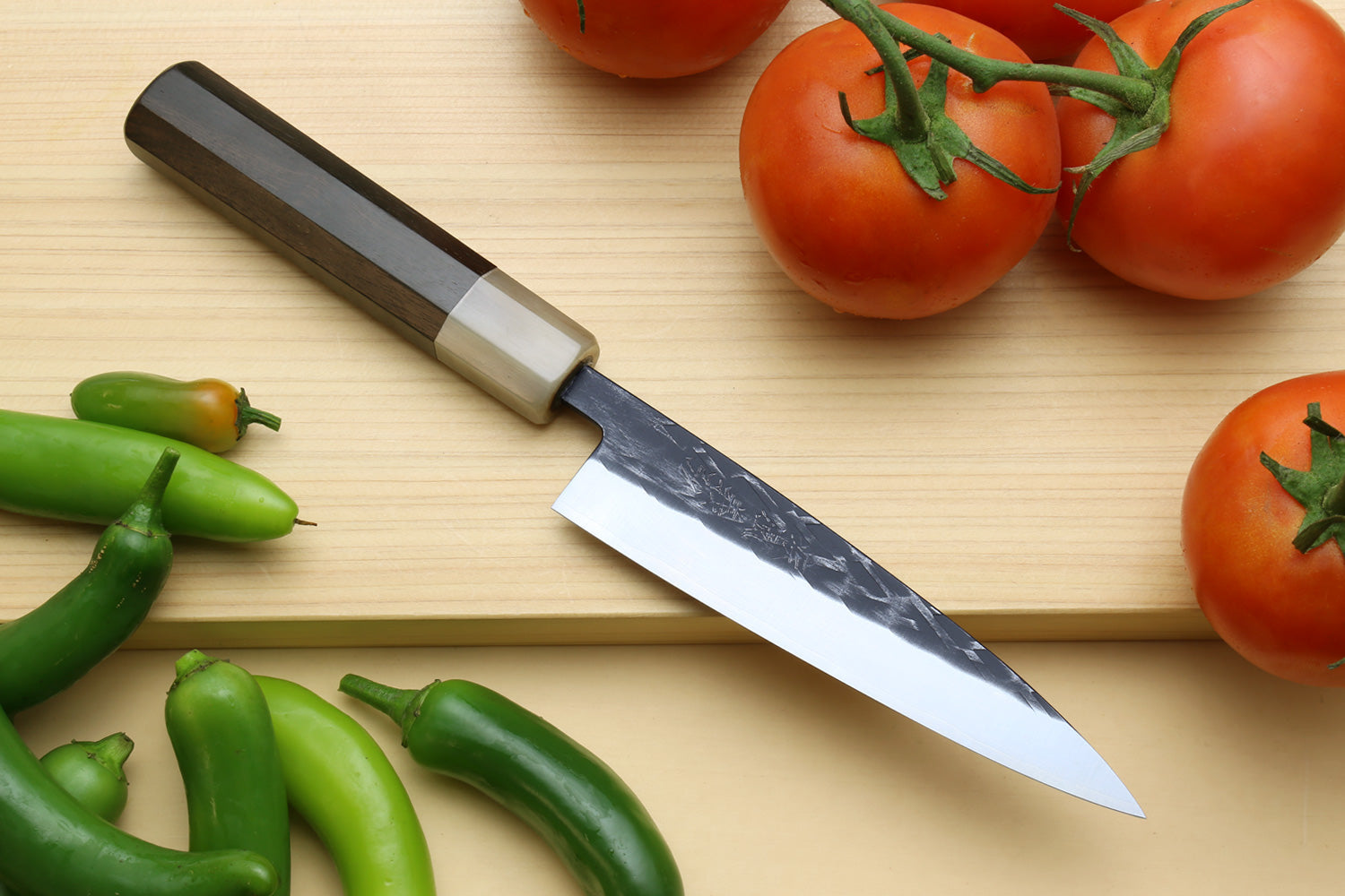 Yoshihiro petty knife on a cutting board