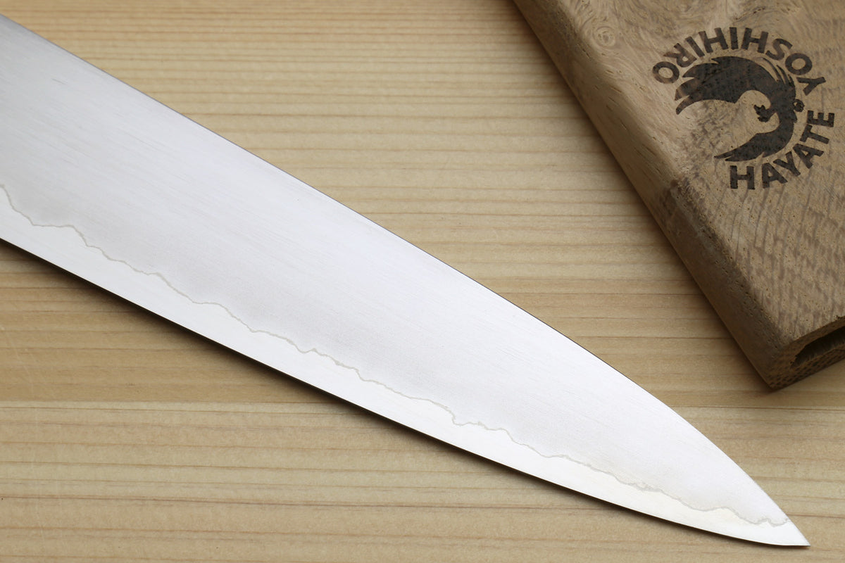 Sujihiki slicer knife showing wavy edge near tip and smooth white spacer