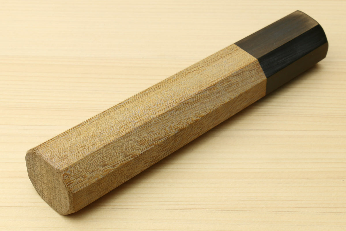 Ambrosia wood handle with dark ebony bolster sleeve and tapered grip, close-up, for Petty knives
