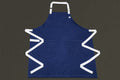 Dark denim kitchen apron front view with white neck strap and waist ties