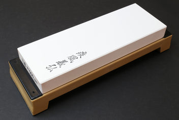 Sharpening whetstone with white rectangular stone block on beige base