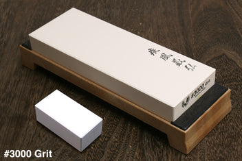Sharpening whetstone 3000 grit with white stone block on wooden base, black side plate