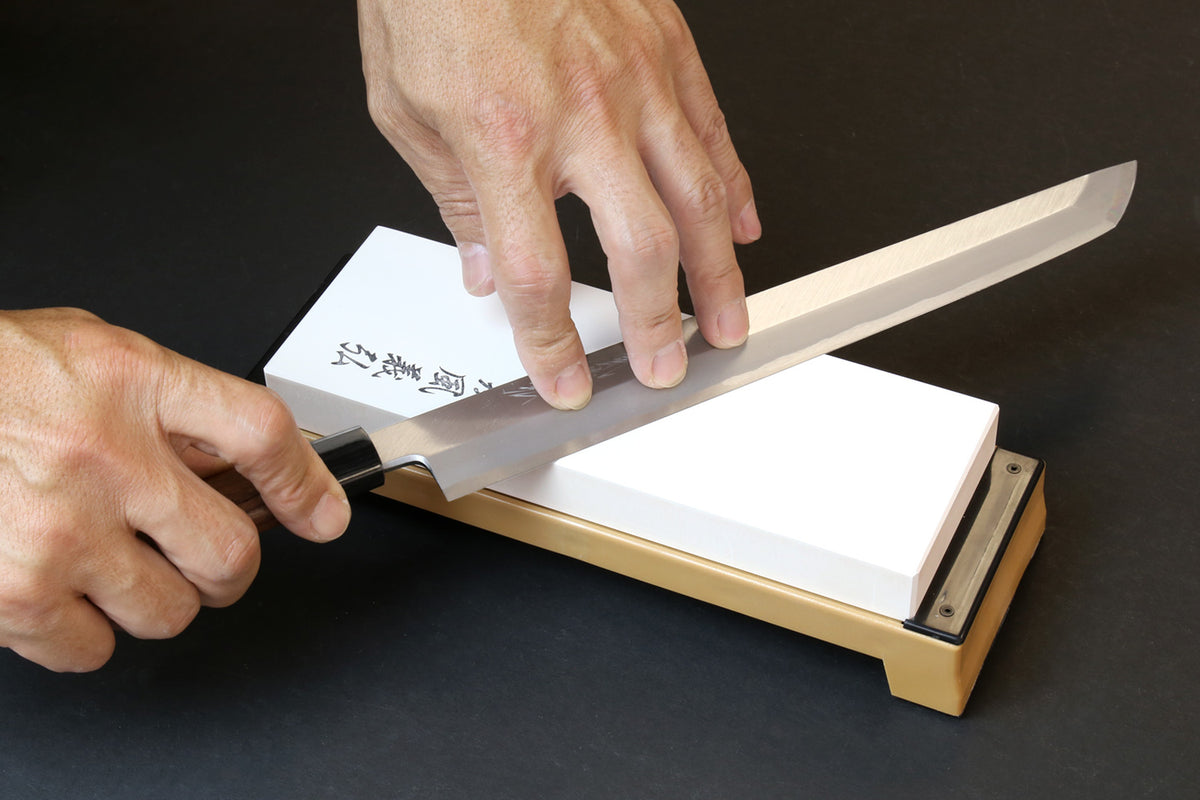 8000-grit sharpening whetstone with white stone on tan holder