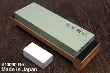 10,000-grit sharpening whetstone on wooden base, pale green stone