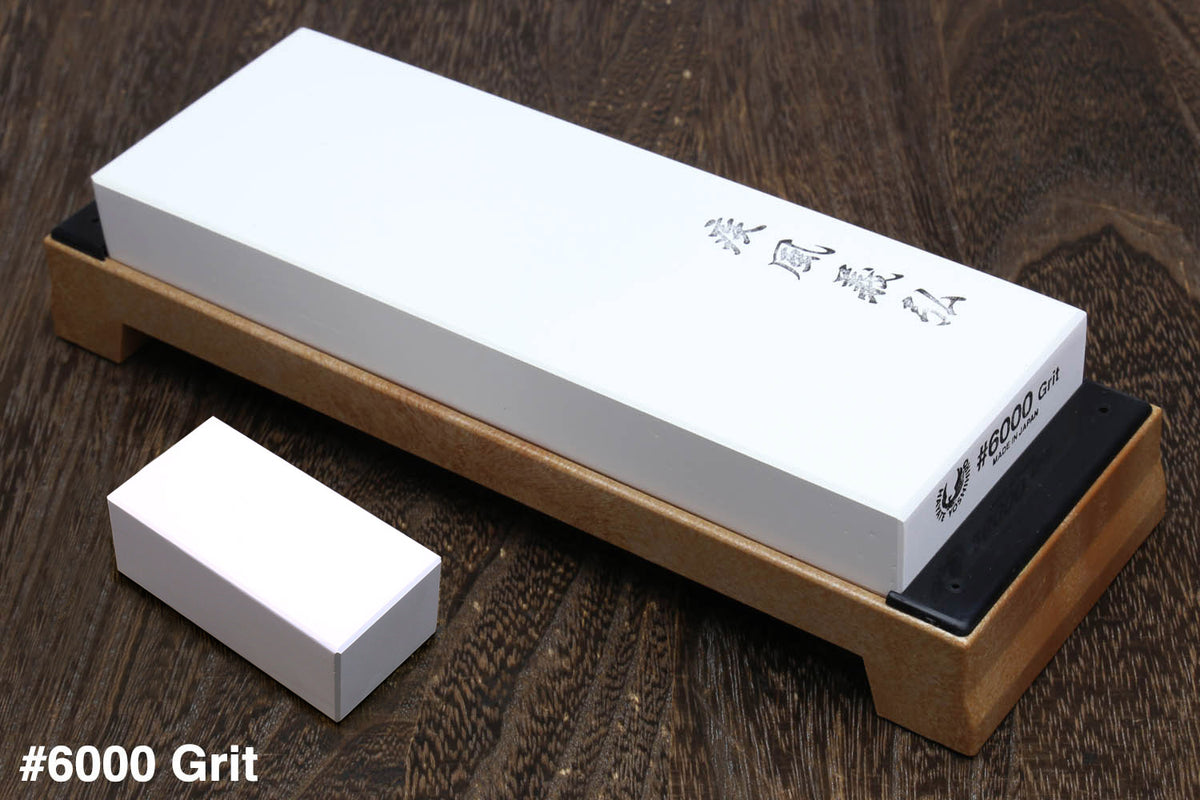 6000 grit sharpening whetstone with white stone on tan base, rectangular black label