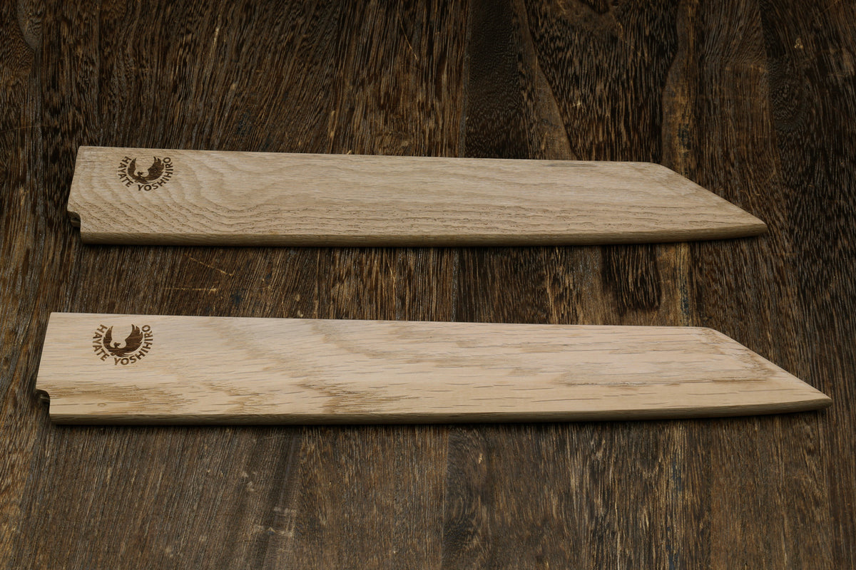 Pair of light oak wooden saya covers with brand emblems, side by side