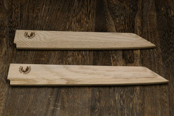 Pair of light oak wooden saya covers with brand emblems, side by side