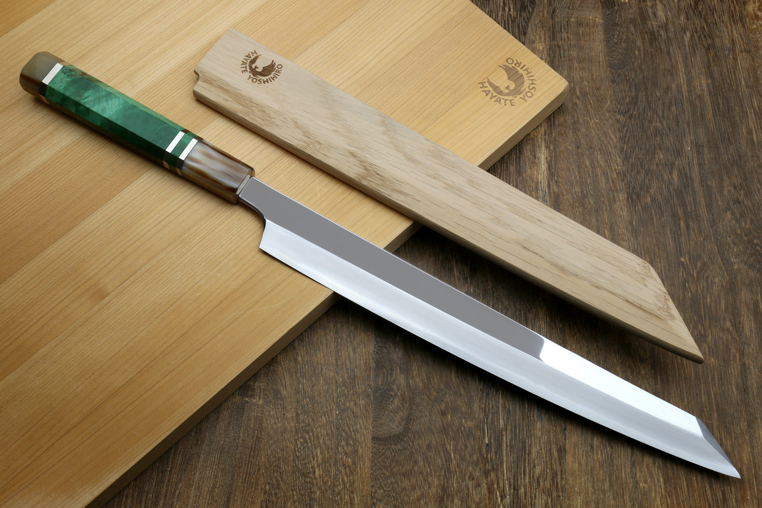 Traditional Japanese knife with wooden sheath on a wooden surface