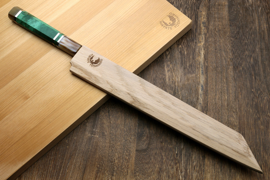 Knife with a green handle on a wooden cutting board