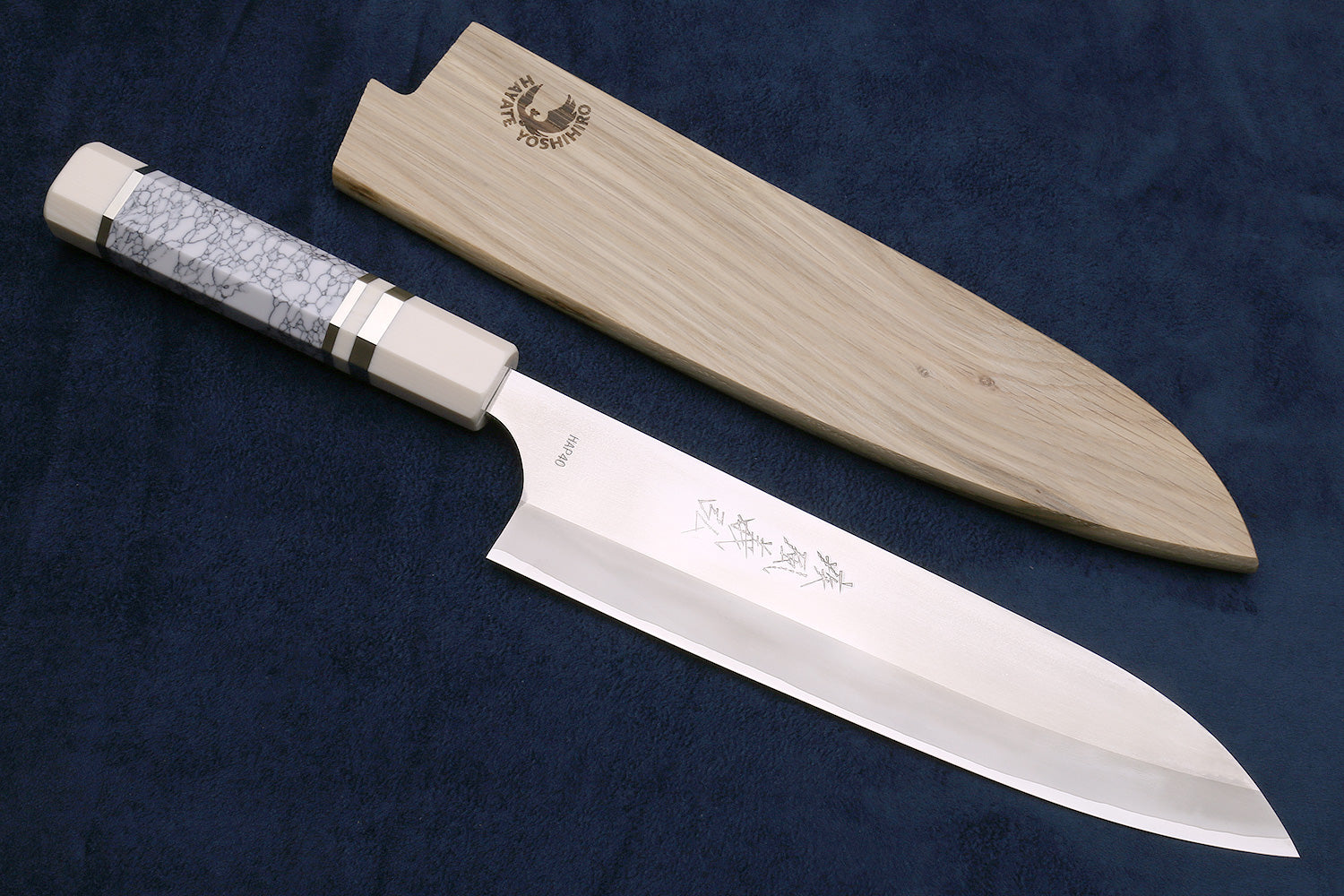 Chef's knife with wooden sheath on a dark blue background