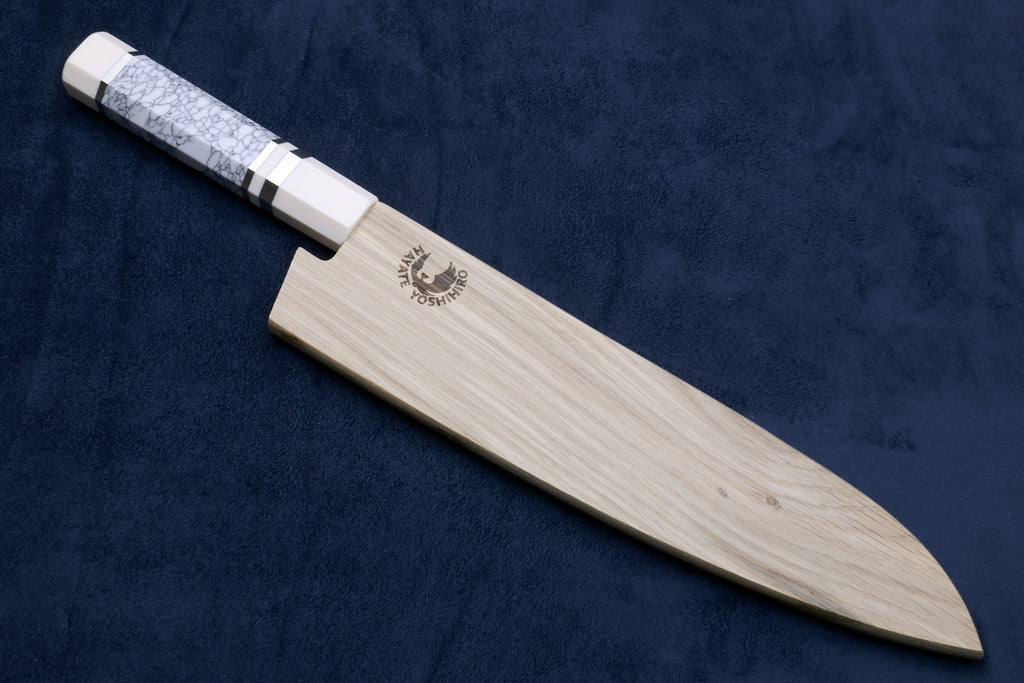 Sleek knife with a brand logo on a dark blue background