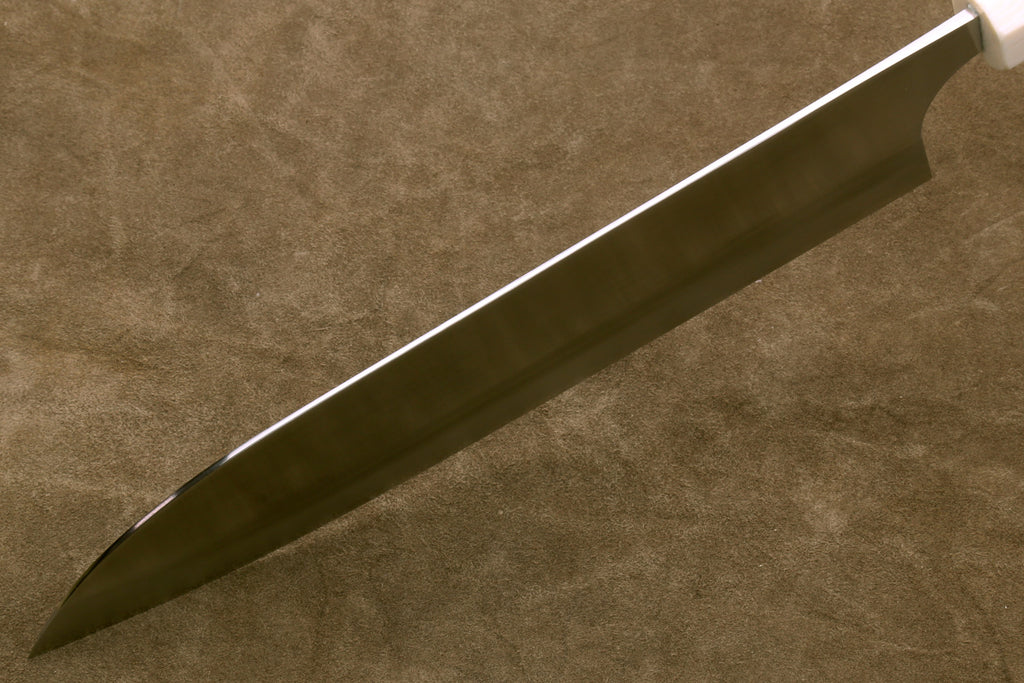 Long knife blade on a textured brown background