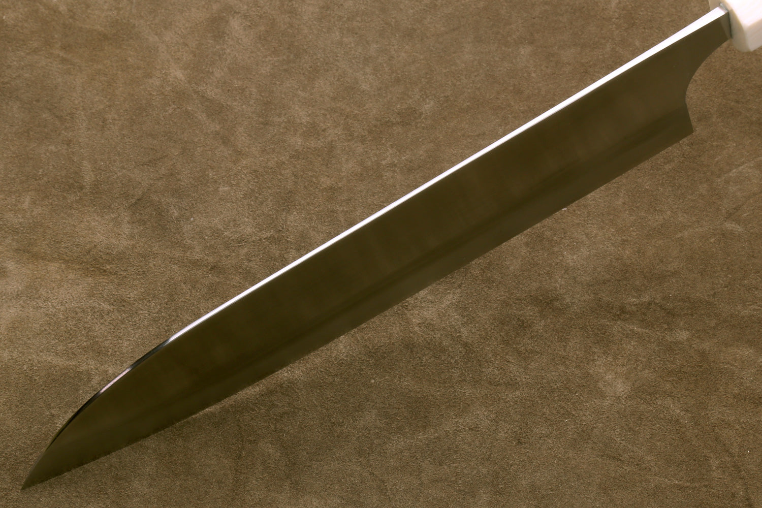 Long knife blade on a textured brown background