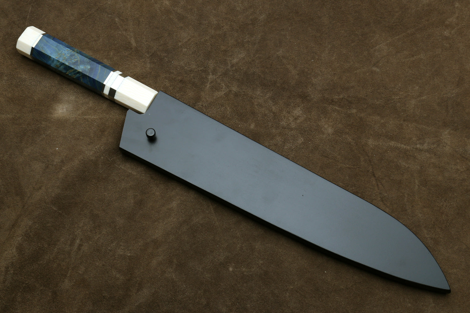 Knife with a blue handle on a brown leather background
