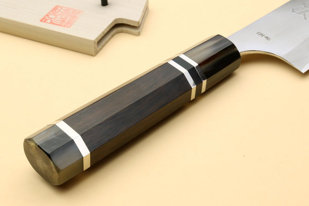 Chef knife showing dark ebony handle with triple silver rings