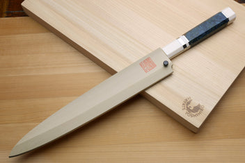 Left-handed yanagi sushi knife on wooden board: ivory handle with blue bands