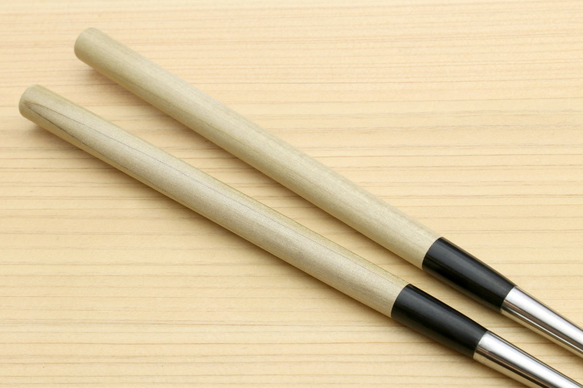Sushi tweezers with two light wood handles and black collar, stainless tips