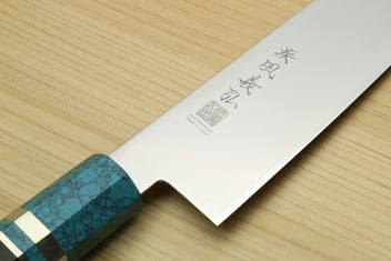 Stainless steel gyuto chef knife blade with etched characters, turquoise blue handle