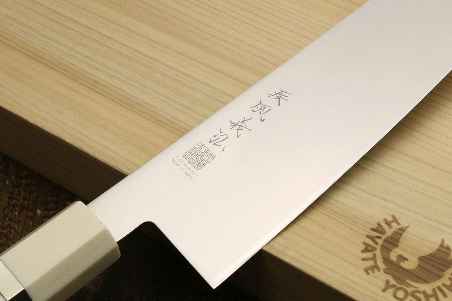 Kiritsuke chef knife blade close-up with etched markings; ivory-look bolster and rosewood handle.