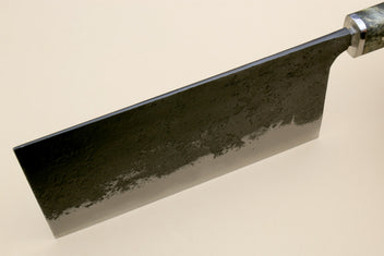 Chinese-style cleaver knife side view with dark speckled steel blade