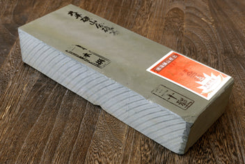 Natural sharpening whetstone with end labels, rectangular stone block