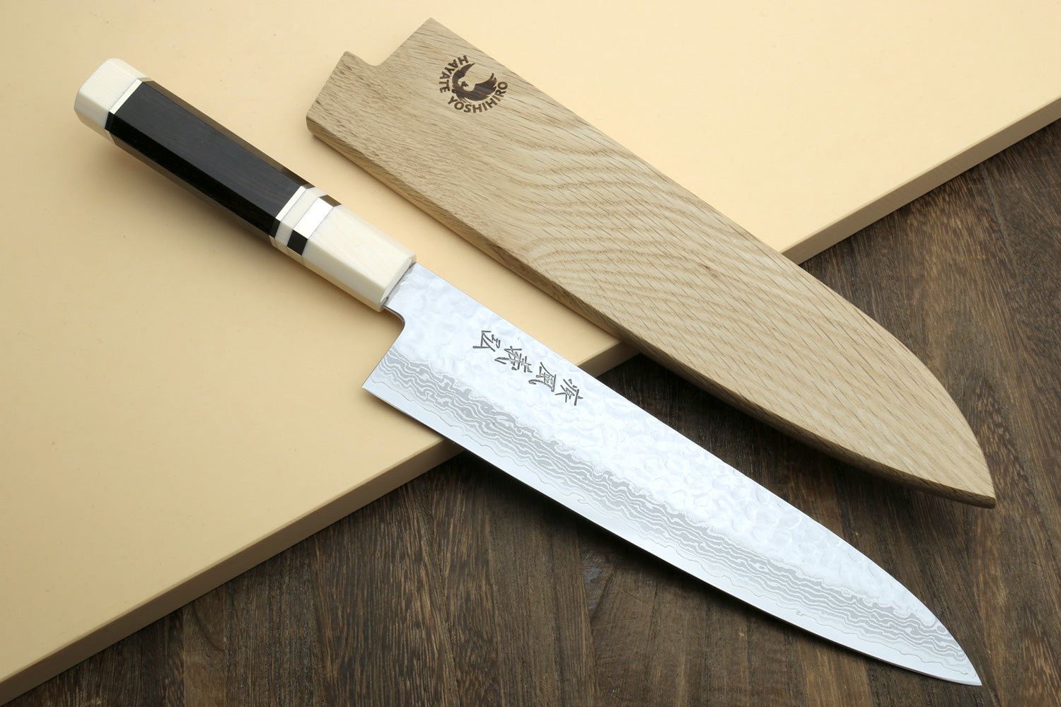 Damascus knife set showing gyuto and petty blades with ivory-look handles