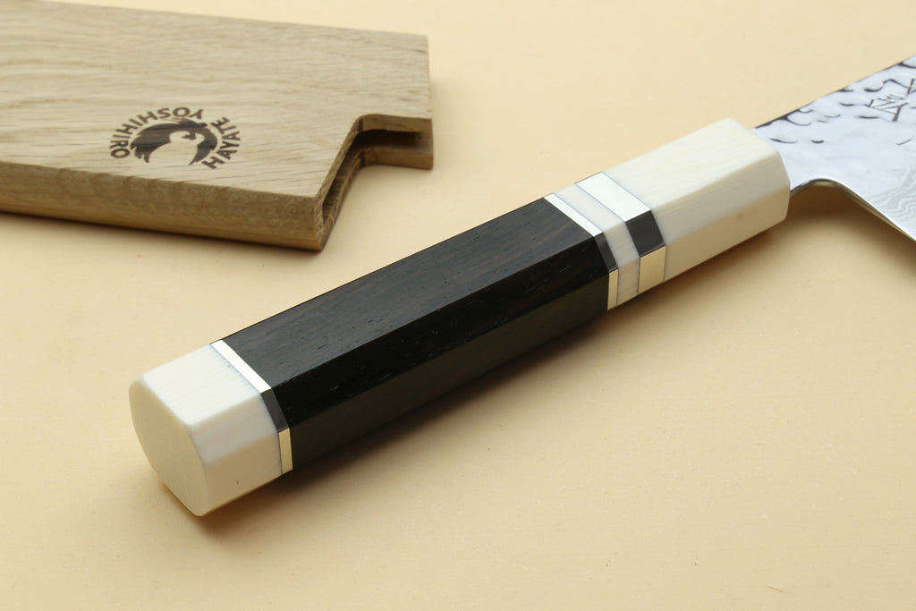 Ivory-look octagonal handle with black accent bands and Damascus blade