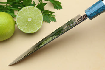 Petty utility chef knife with Damascus blade and turquoise blue octagonal handle.