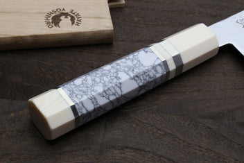 Howlite white santoku handle with marbled pattern, ivory-toned bolster, damascus blade