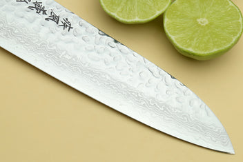 Santoku knife blade with hammered Damascus pattern and etched characters