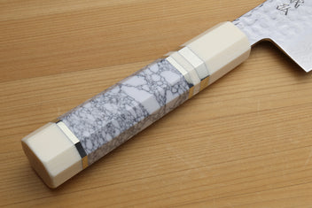 White howlite handle with gray veining on hammered Damascus nakiri blade