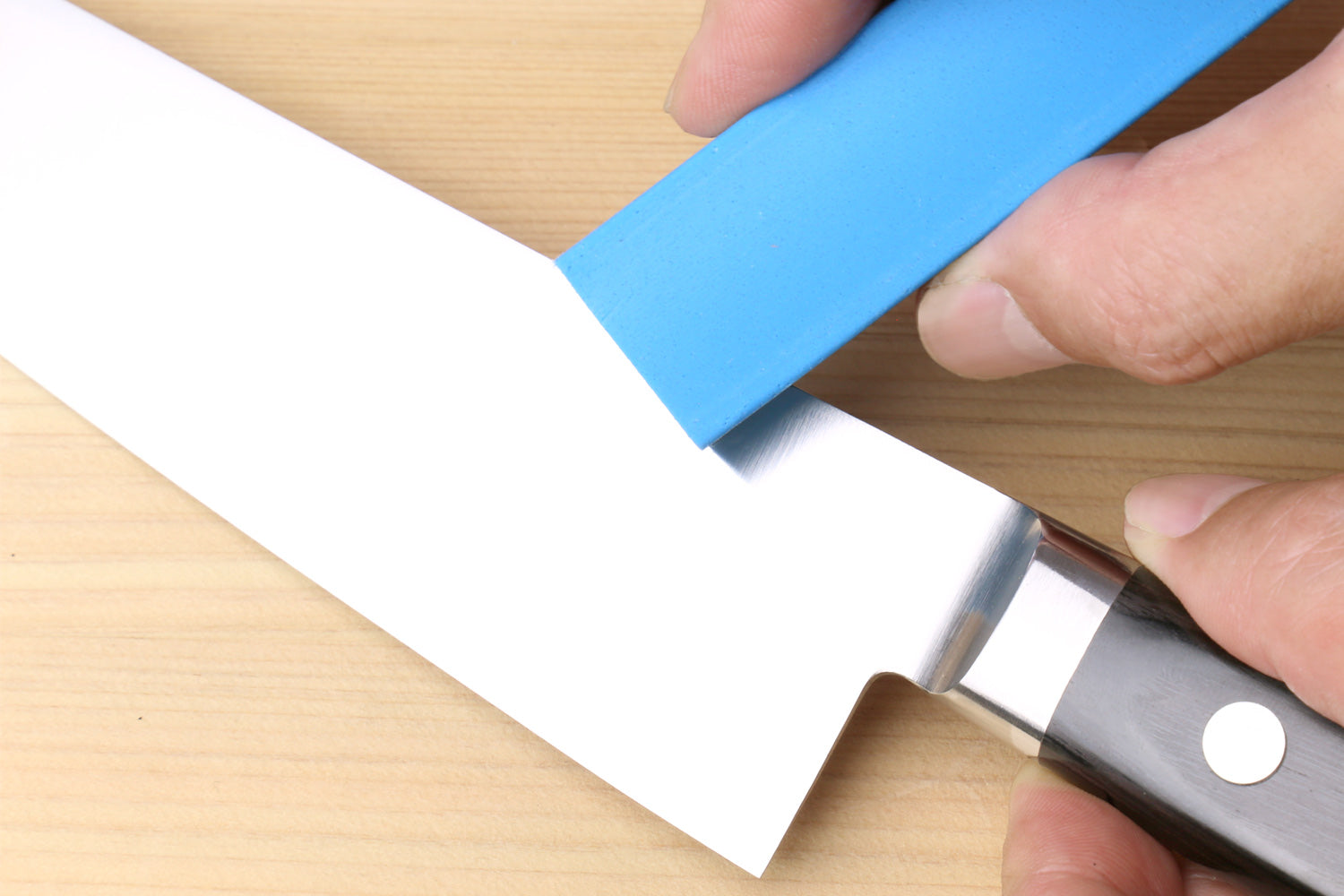 Sabitori rust eraser removing rust spots from a Japanese knife blade
