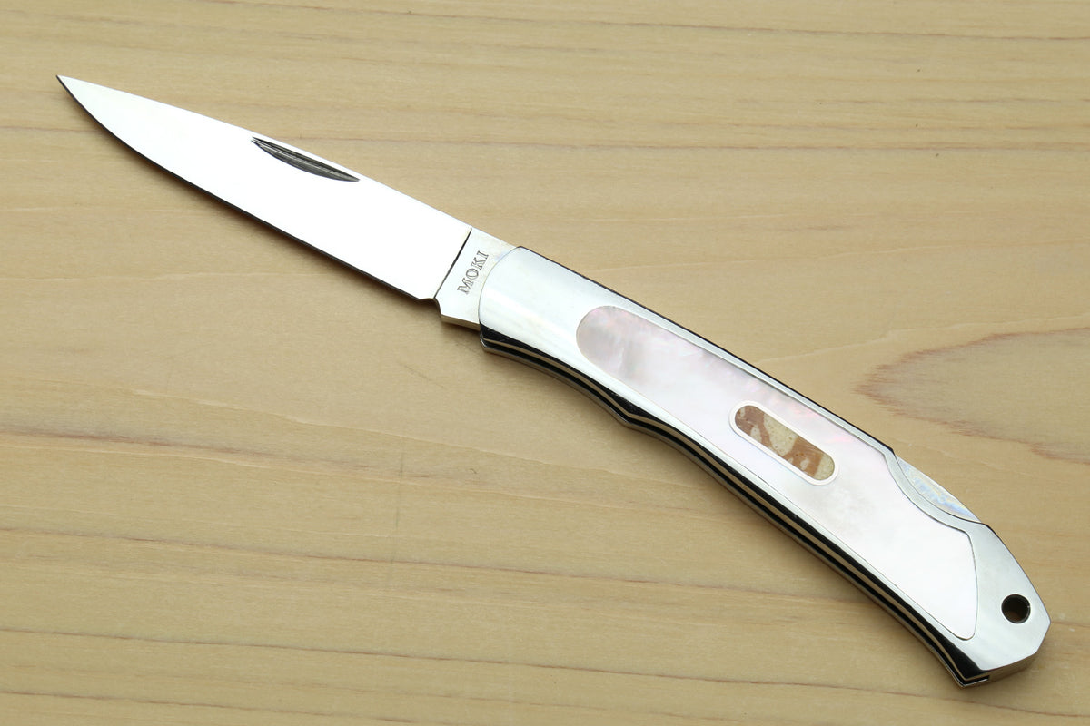 Stainless steel lockback folding pocket knife with white handle and abalone inlay