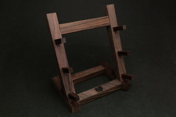Ebony and rosewood knife rack stand with vertical posts and angled base supports