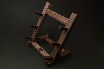 Ebony and rosewood knife rack stand viewed from the side with staggered knife rests