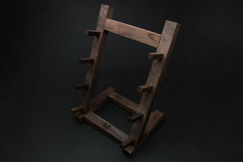 Ebony and rosewood knife rack stand with dark vertical supports and central open base
