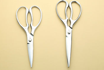 Pair of stainless steel kitchen shears with loop handles and pointed tips