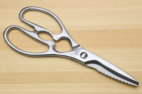 Stainless steel kitchen shears with straight and scalloped grip blades and oval loop handles.