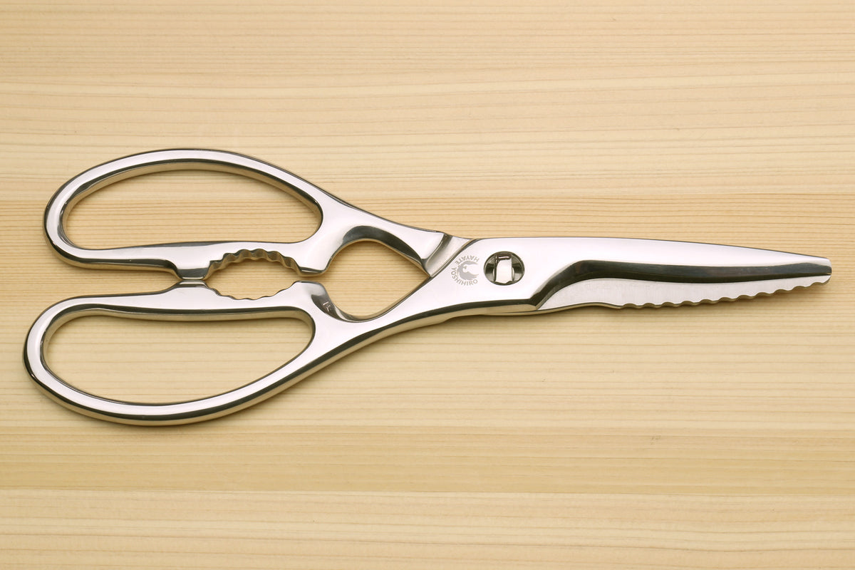 Stainless steel Japanese kitchen shears with straight and scalloped grip cutting edges and loop handles.