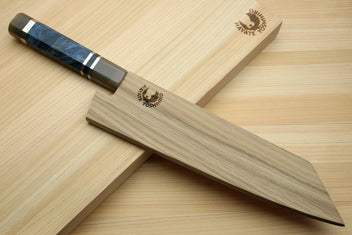 Kiritsuke chef knife with ocean blue handle and Damascus blade on light wood tray