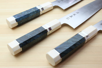Three gyuto chef knives with ocean blue handles and ivory bolsters, stainless blades
