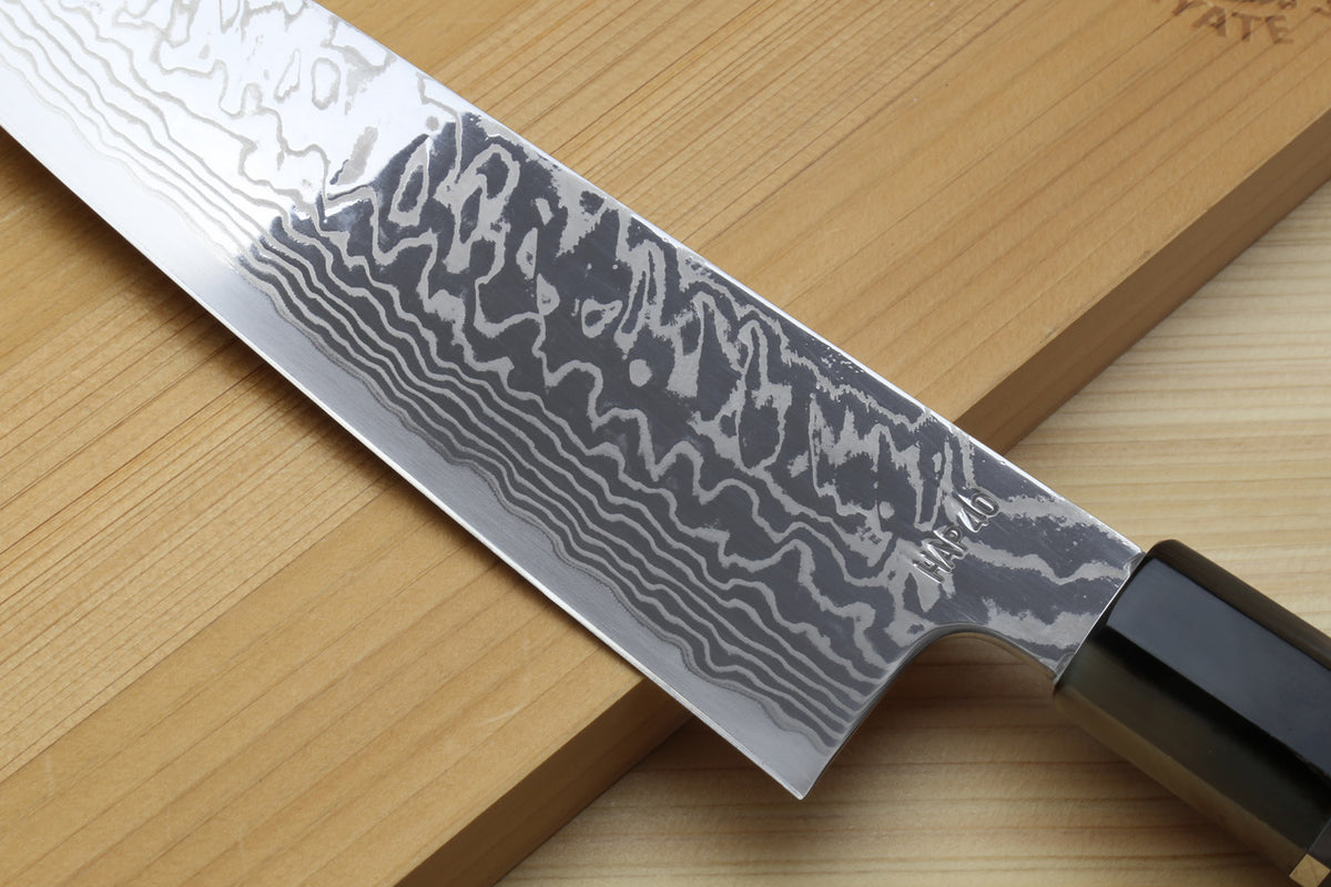 Gyuto chef knife with damascus blade pattern and ocean blue handle, curved heel
