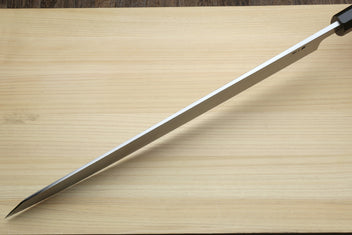 Yanagi kiritsuke blade close-up with pointed tip and etched steel finish