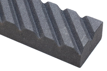 Sharpening stone fixer, black textured ridged surface in close view