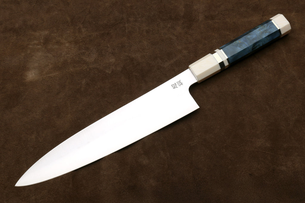 back side of a chef's knife on a brown surface