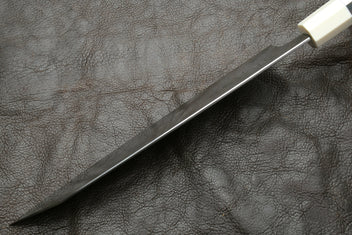 Kiritsuke knife with stainless steel blade and ivory bolster, angled view