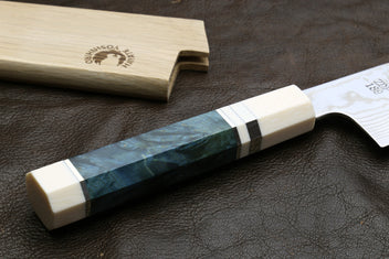 Damascus gyuto chef knife with ivory handle scales and teal bolster, bolster-close view