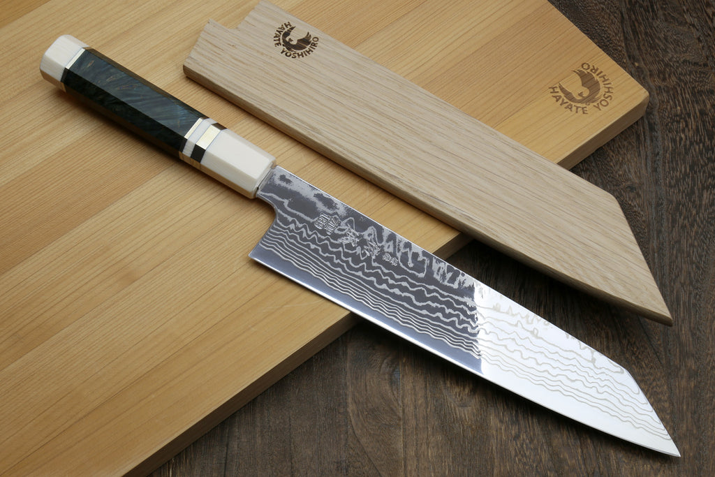 Japanese chef's knife with a wooden sheath on a wooden surface