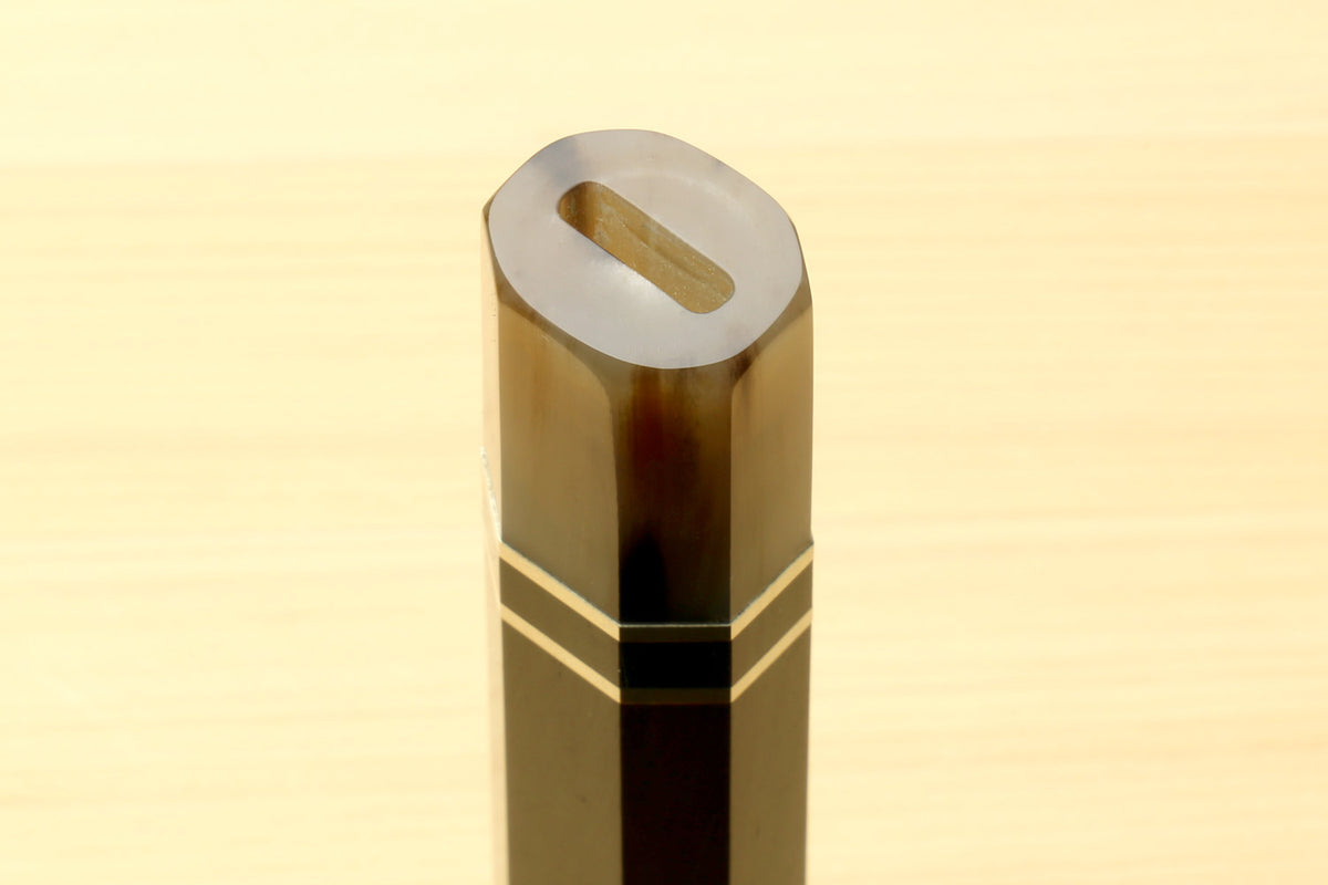 Chef knife handle end with horn bolster and triple ring stripes, thumb slot visible, for Kiritsuke knives
